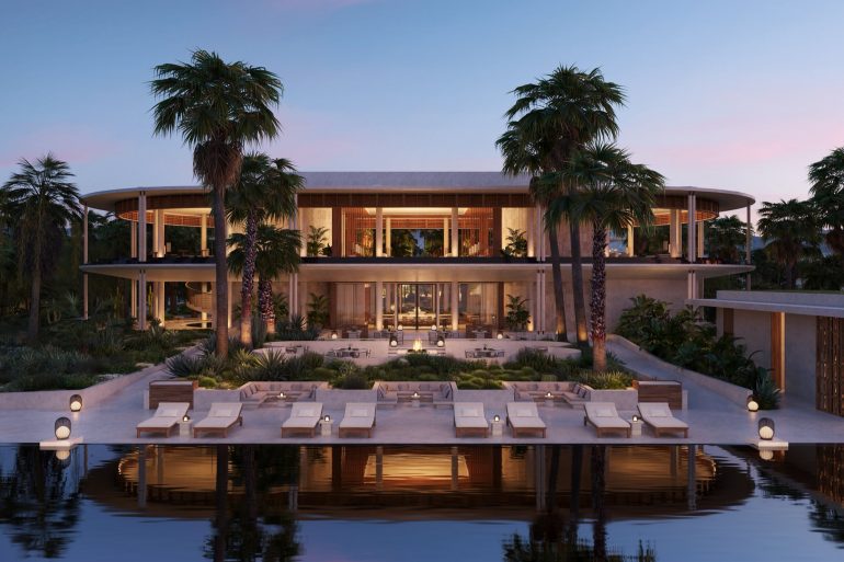 Modern tropical resort with an open-air lounge, palm trees, and poolside seating at dusk.