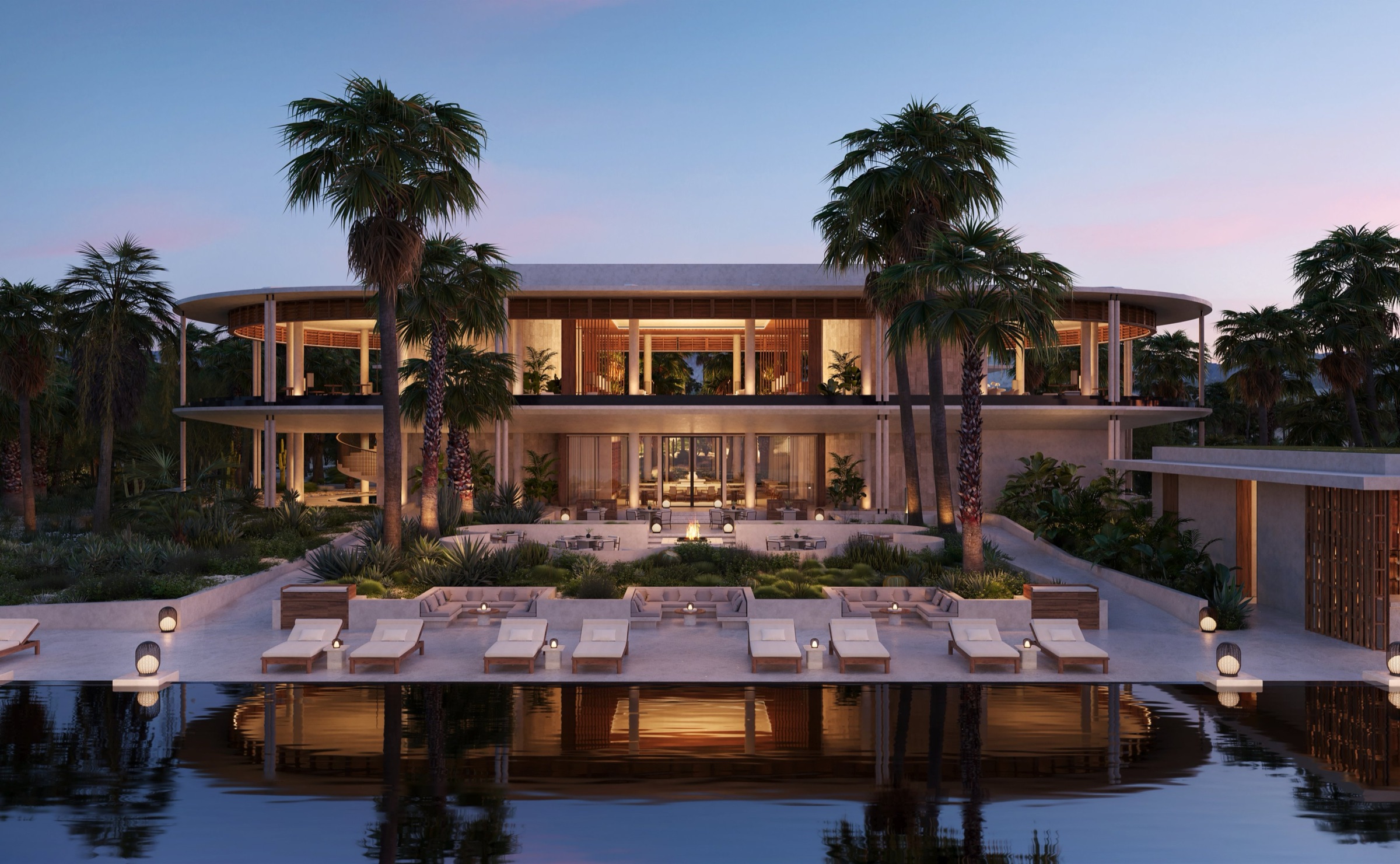 Modern tropical resort with an open-air lounge, palm trees, and poolside seating at dusk.