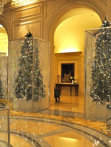 Luxurious interior with sparkling crystal bead curtains in mirrored frames and a chandelier.
