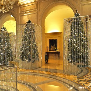 Luxurious interior with sparkling crystal bead curtains in mirrored frames and a chandelier.