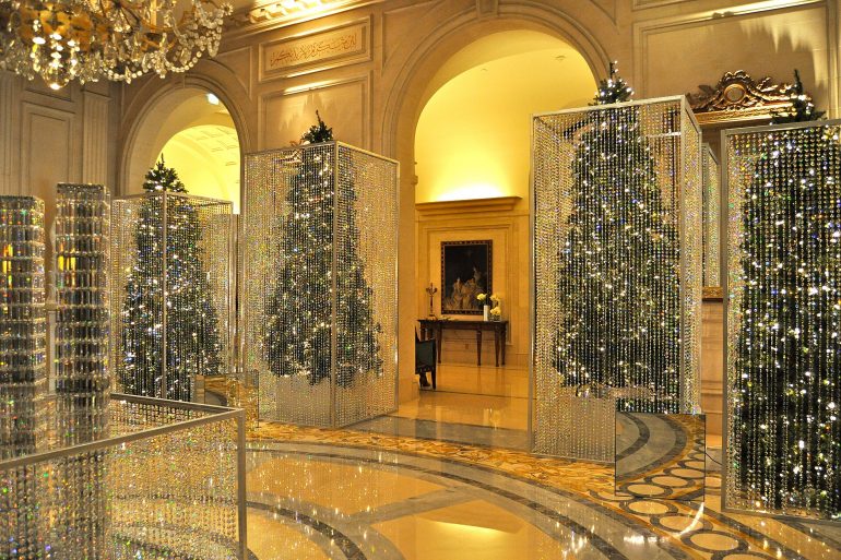 Luxurious interior with sparkling crystal bead curtains in mirrored frames and a chandelier.