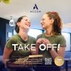 Two smiling women in green shirts share a moment in a modern cafe; ACCOR logo above and 'TAKE OFF!' headline overlaid.