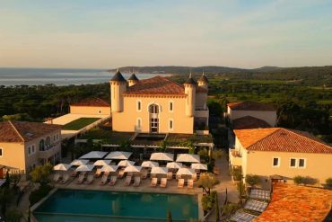 Un palace méditerranéen avec piscine au soleil couchant, sur fond de canicule