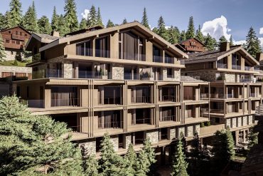 Modern multi-story wooden chalet complex with stone accents in a forested mountain setting