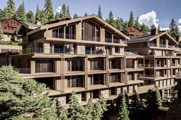 Modern multi-story wooden chalet complex with stone accents in a forested mountain setting