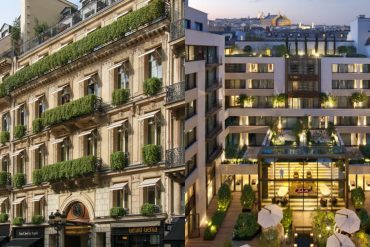 Split view: historic Parisian building with green balconies beside a modern courtyard hotel lobby at dusk, illustrating old vs new architecture.
