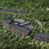 Modern hillside resort with dark-roofed lodges nestled among dense trees and winding paths on a forested slope