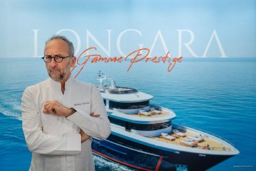 Chef Michel Portos in a white coat with folded arms stands before a blue backdrop featuring a luxury yacht and the text ‘Gamme Prestige’.