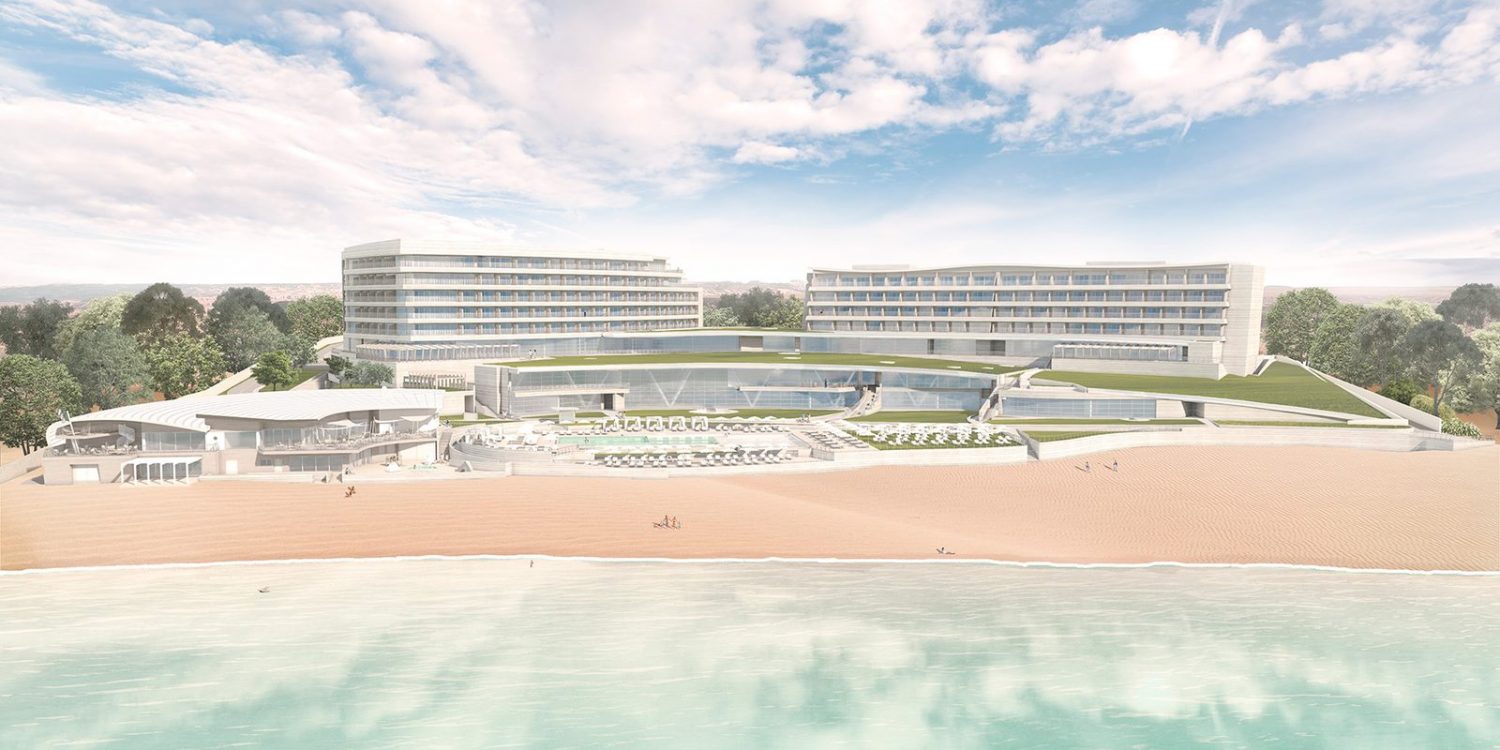 Modern beachfront hotel complex with two curved glass buildings, pool, and sandy shore.
