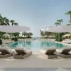 Piscine du Delano Dubai à Bluewaters, parasols et transats sous les palmiers, hôtel Ennismore du groupe Accor à Dubaï