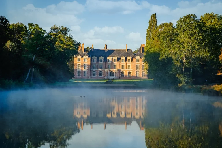 The Château de La Borde reflected in its lake at dawn, in Vernou-en-Sologne, Loire Valley