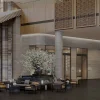 Lobby à double hauteur du Shilla Monogram Hanoi West Lake, claustras de bois ajouré, colonnes de pierre et salon devant les baies vitrées