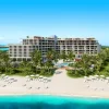 Rendu de l'Andaz Turks & Caicos at Grace Bay vu depuis la plage de Grace Bay, ses deux bâtiments, ses palmiers et ses transats