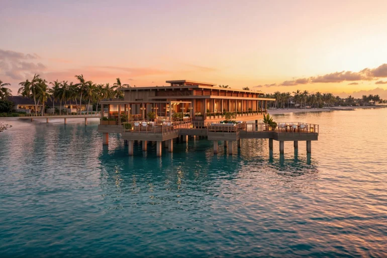 Rendu des bungalows sur pilotis du Four Seasons Resort Caye Chapel, au Belize, au coucher du soleil