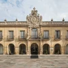 Façade baroque en pierre de l'hôtel Eurostars de la Reconquista à Oviedo, avec ses arcades et le grand blason sculpté
