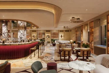 Rendu du bar lounge de l'hôtel Six Senses Milan, comptoir rouge et colonnes de marbre veiné