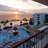 Rendu des piscines du resort The Pyrmont Curaçao, nouvel hôtel tout compris pour adultes, face à la mer des Caraïbes au coucher du soleil, à Willemstad